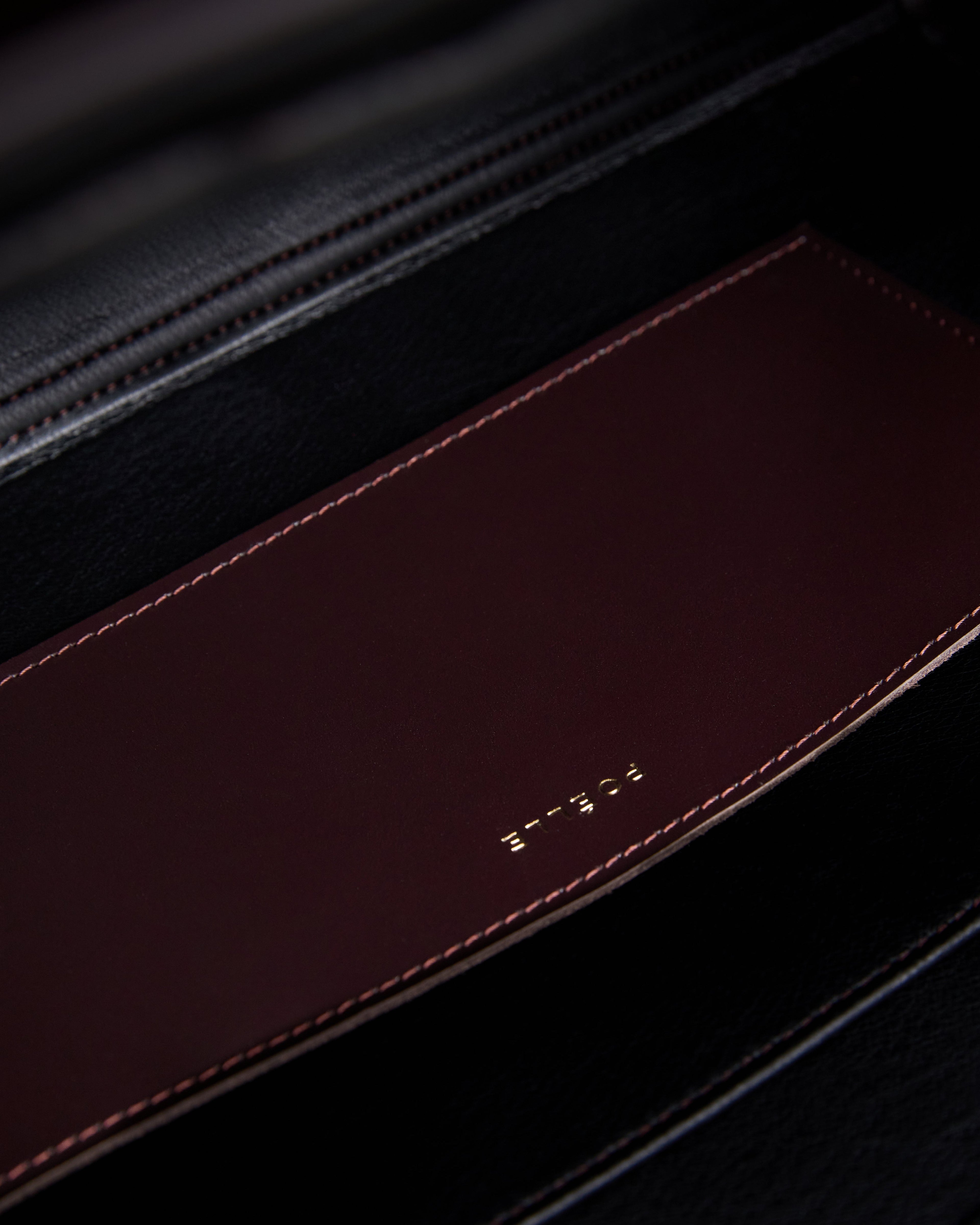Close-up of the interior pocket detail in a brown leather tote bag by Poelle Atelier