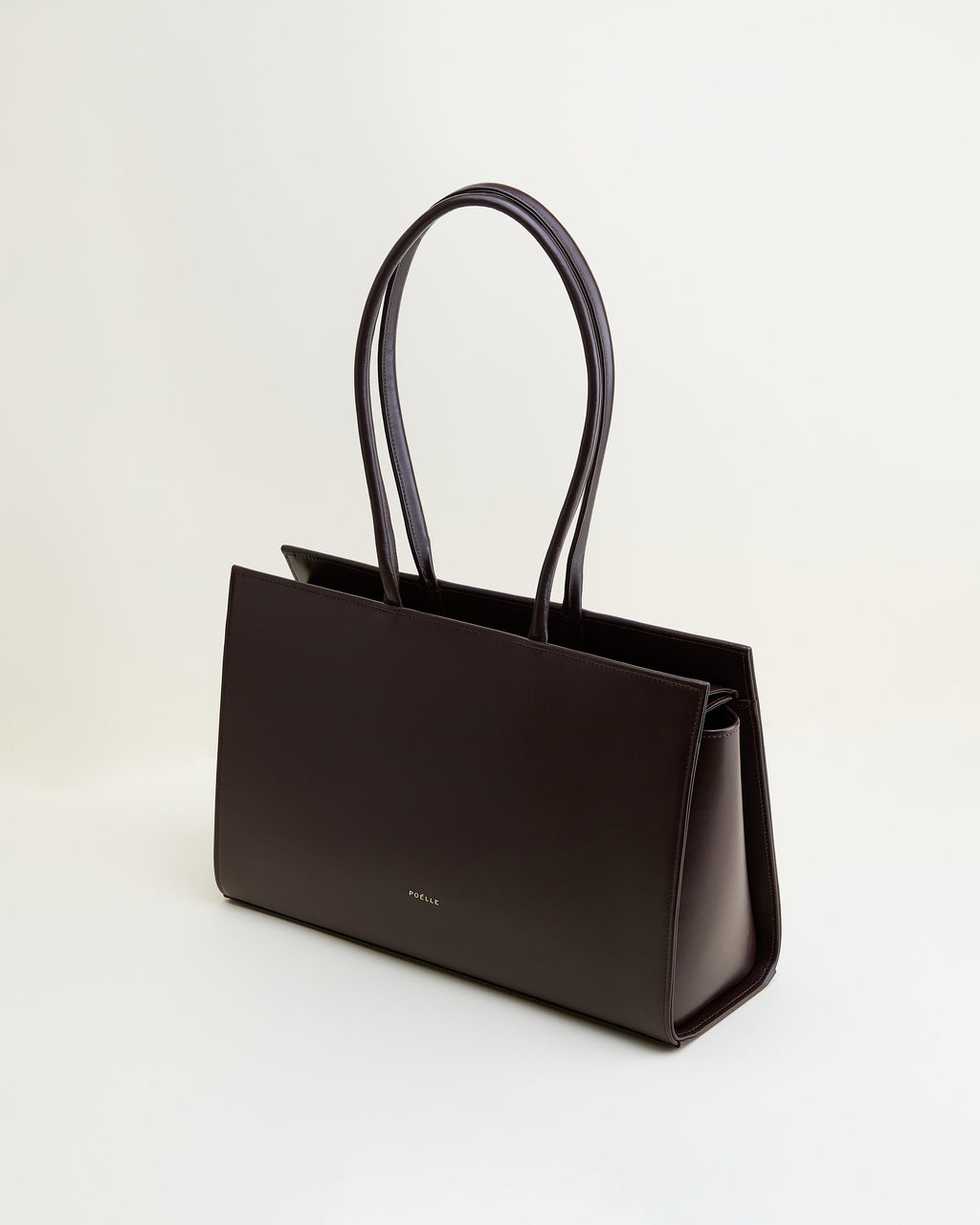 Poelle Atelier sleek brown leather tote bag with long handles and minimalist design