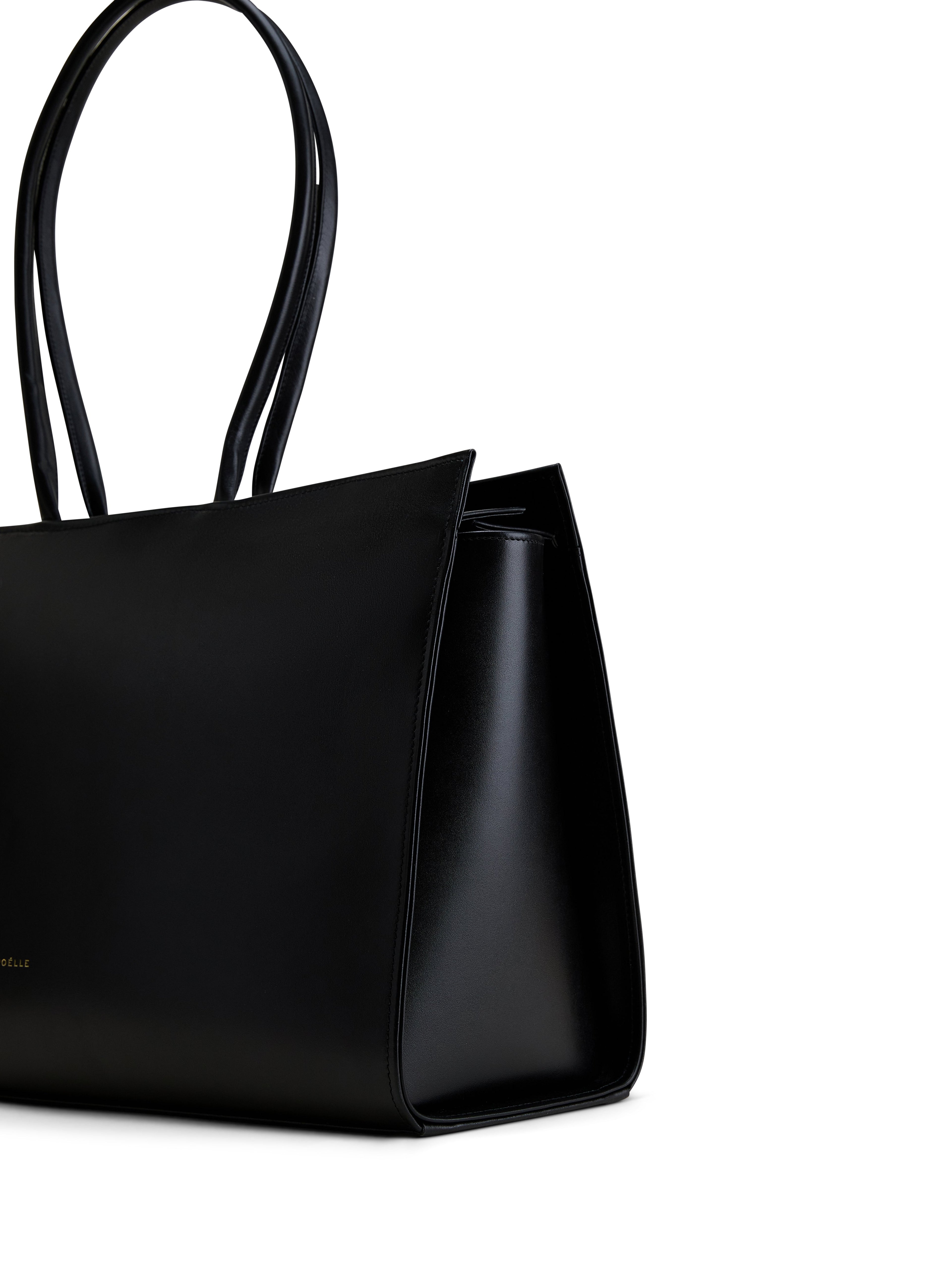 Luxury black leather tote from Poelle Atelier with sleek design and long handles